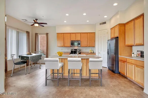 a large kitchen with a table and chairs