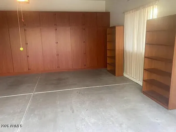 a view of an empty room with closet area