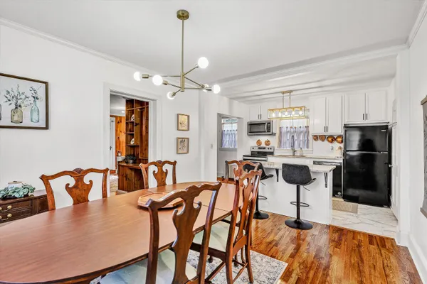 a kitchen with granite countertop stainless steel appliances a stove microwave and sink
