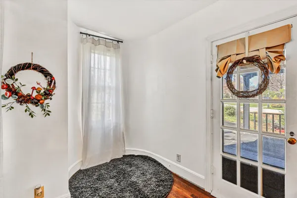 a view of entryway and hall with wooden floor