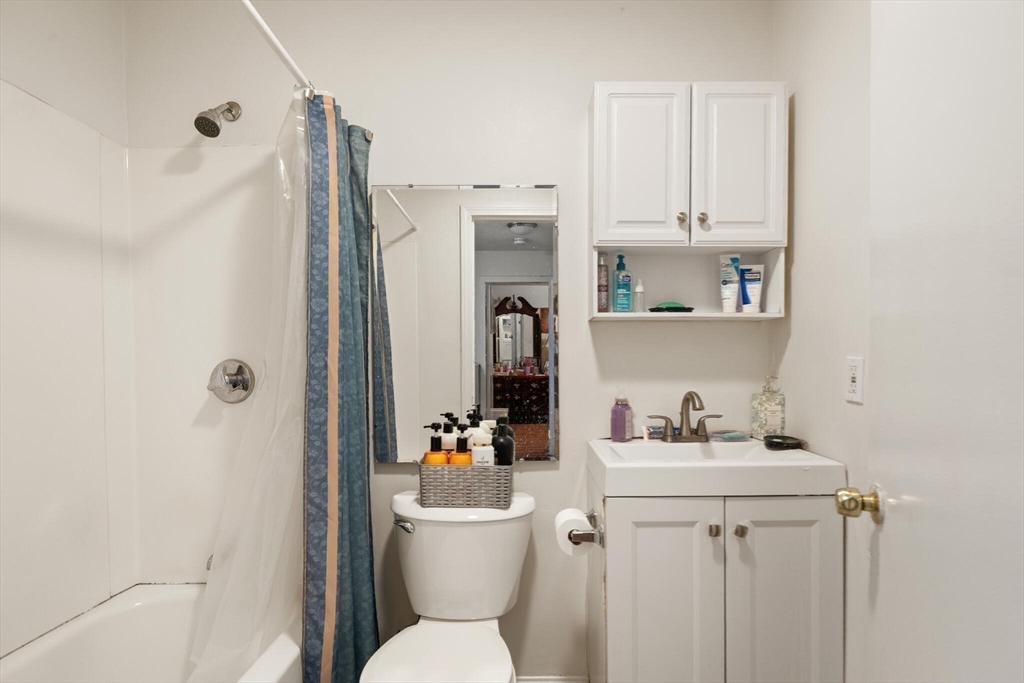 136 Franklin Street Lynn, MA 01902 - Photo 14 of 33 a bathroom with a refrigerator sink vanity and toilet