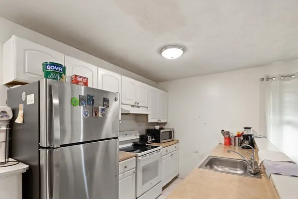 a white refrigerator freezer sitting inside of a kitchen