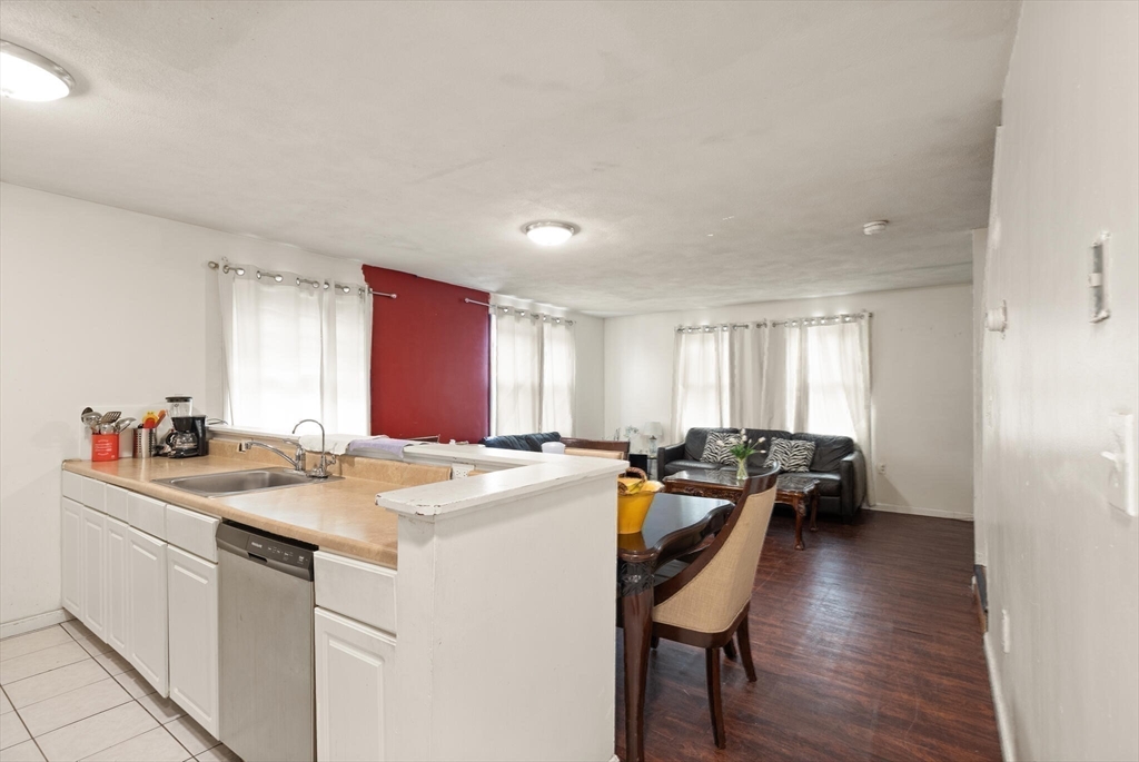 136 Franklin Street Lynn, MA 01902 - Photo 23 of 33 a kitchen that has a sink and chairs in it