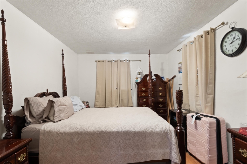 136 Franklin Street Lynn, MA 01902 - Photo 24 of 33 a bed room with a bed and a chair