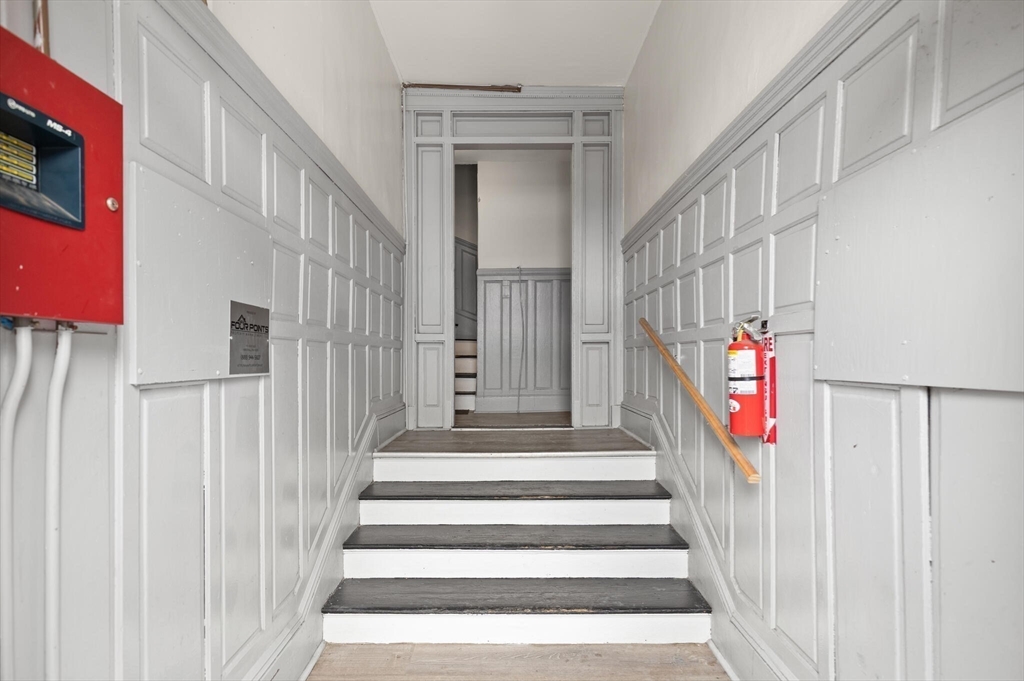 136 Franklin Street Lynn, MA 01902 - Photo 8 of 33 a view of staircase with lots of frames on wall and a window