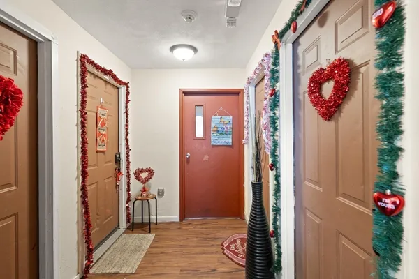 a very nice looking hallway with a flower pot and a bookshelf