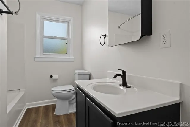 a bathroom with a sink toilet and vanity