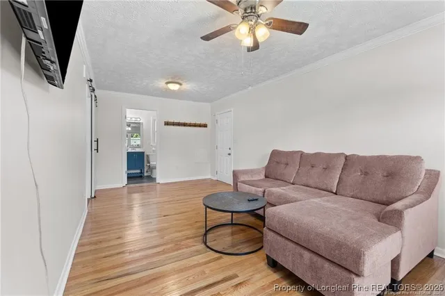 a living room with furniture and a wooden floor