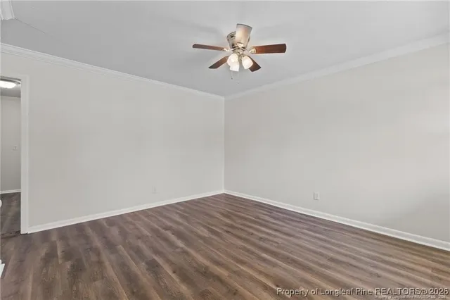 a view of a room with wooden floor and a ceiling fan