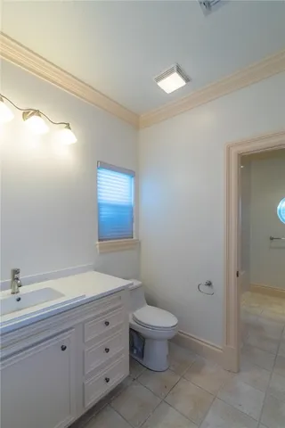 a bedroom with a bed couch chandelier and a window