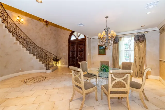 a view of a dining room with furniture and chandelier