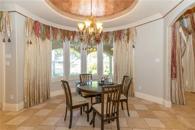 a view of a dining room with furniture and chandelier curtains