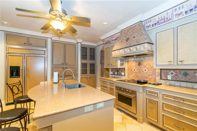 a kitchen with stainless steel appliances a stove a sink and a refrigerator