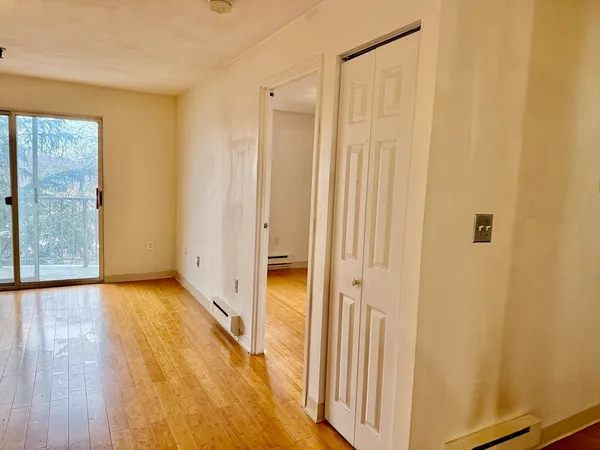 a view of a bathroom with wooden floor and a window