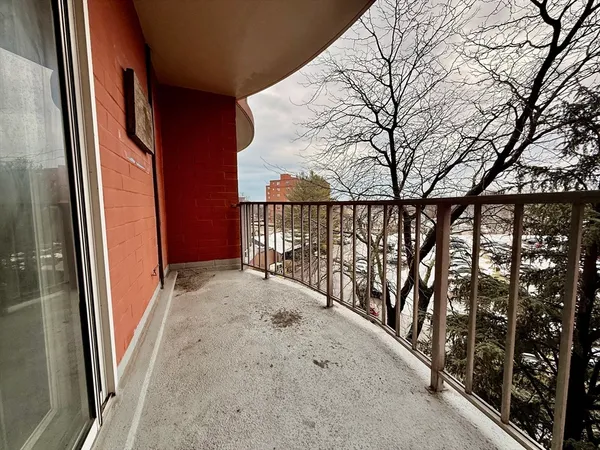 a view of balcony with wooden floor and fence