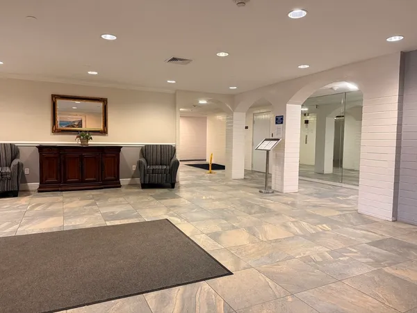 a view of a hallway with seating area