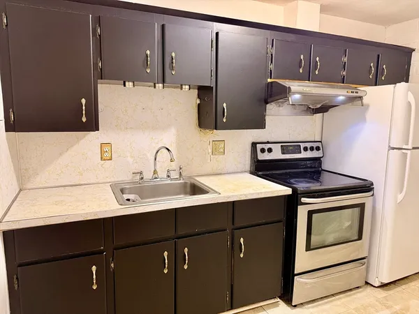 a kitchen with a sink cabinets and appliances