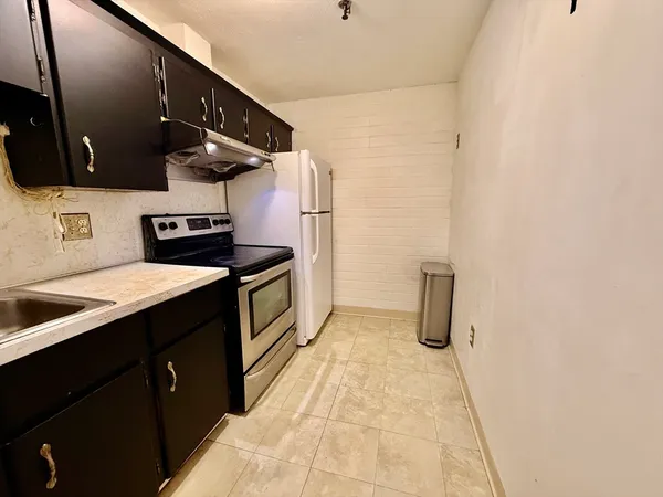 a kitchen with a sink and a stove top oven