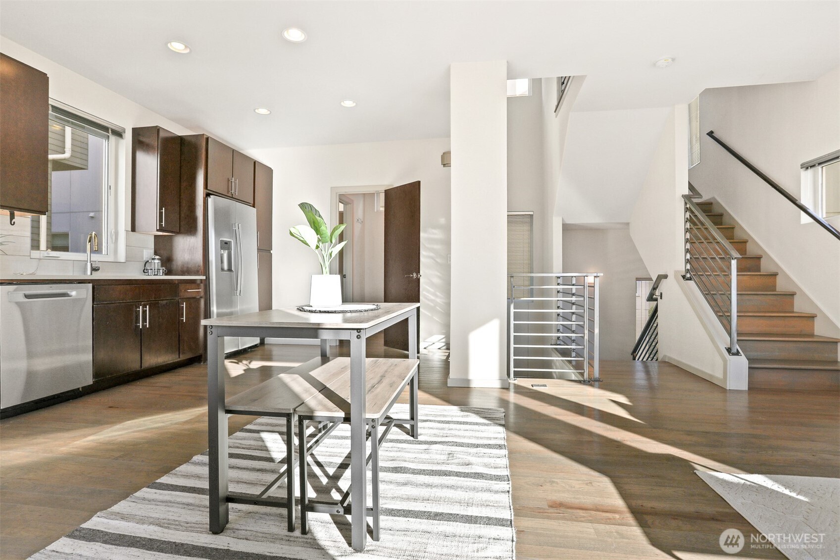 2426B Northwest 64th Street Seattle, WA 98107 - Photo 11 of 38 a view of a dining room with furniture window and wooden floor