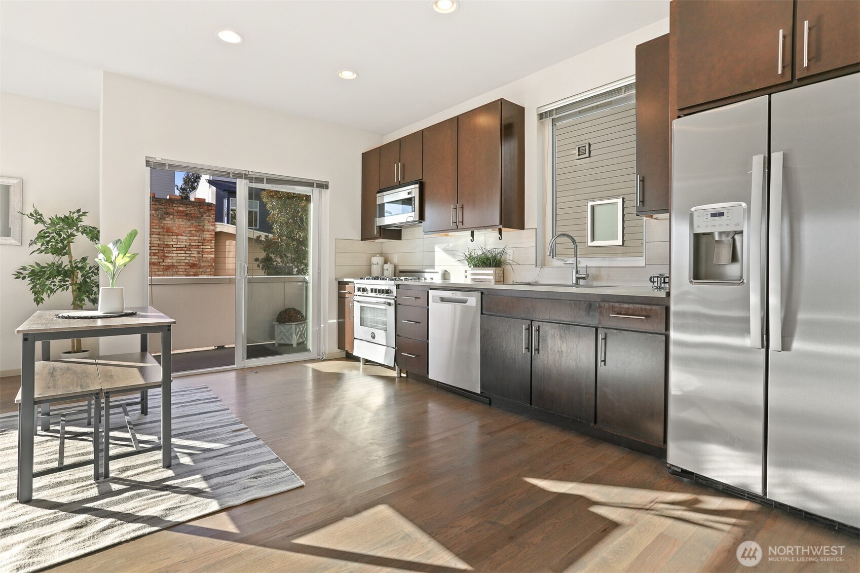 2426B Northwest 64th Street Seattle, WA 98107 - Photo 12 of 38 a kitchen with stainless steel appliances granite countertop a refrigerator and a stove top oven