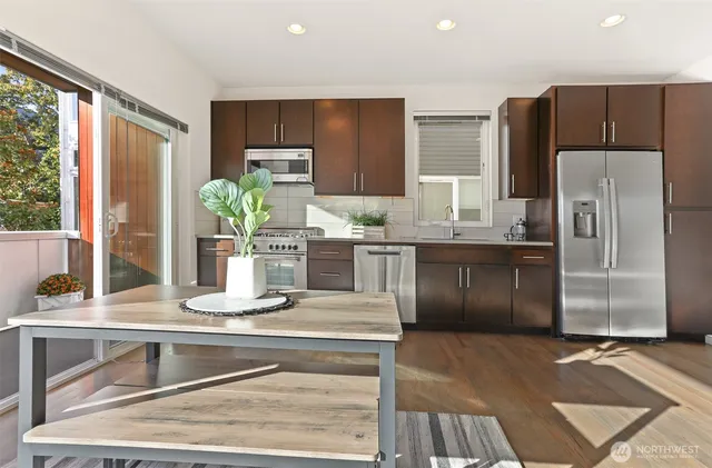 a kitchen with stainless steel appliances granite countertop a refrigerator and a sink