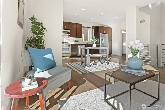 a living room with furniture kitchen and a potted plant