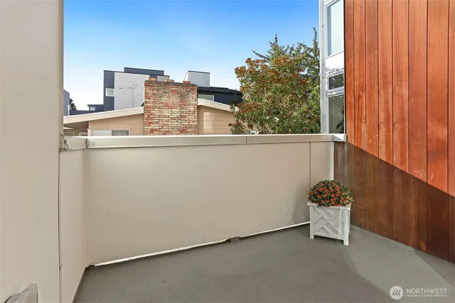 a view of a room with a window and chair