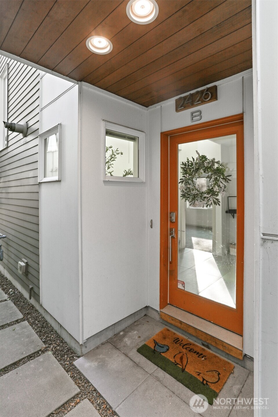 2426B Northwest 64th Street Seattle, WA 98107 - Photo 2 of 38 a view of an empty room with wooden floor and a window