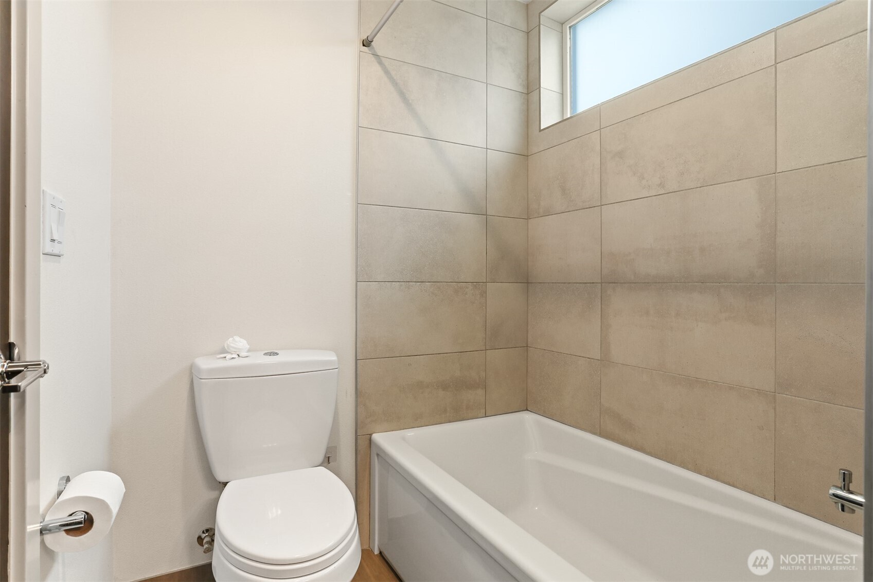 2426B Northwest 64th Street Seattle, WA 98107 - Photo 28 of 38 a white toilet and tub sitting next to a bathroom sink