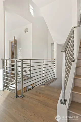 a view of a hallway with stairs and a couch