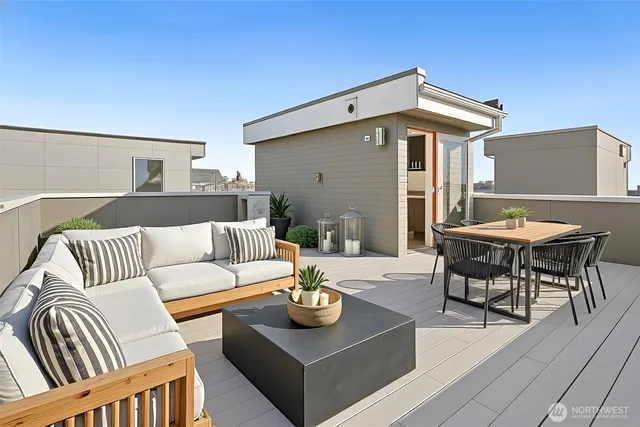 a view of a patio with couches and a table and chairs with wooden floor