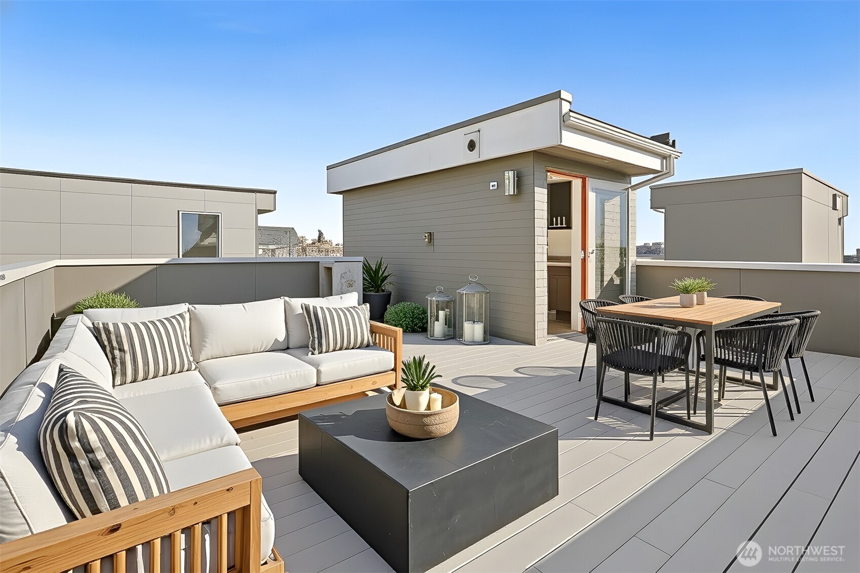 2426B Northwest 64th Street Seattle, WA 98107 - Photo 37 of 38 a view of a patio with couches and a table and chairs with wooden floor