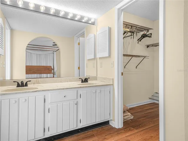 a bathroom with double vanity sink and a mirror