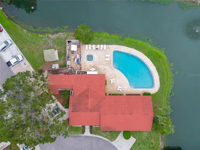 an aerial view of a house with outdoor space and pool