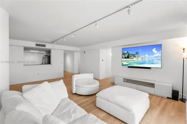 a bedroom with furniture and a flat screen tv