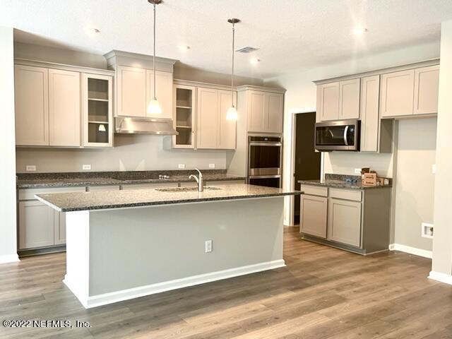 3865 Eagle Rock Road Middleburg, FL 32068 - Photo 4 of 7 a kitchen with stainless steel appliances granite countertop a sink a stove a refrigerator and cabinets