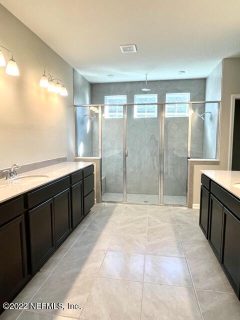 3865 Eagle Rock Road Middleburg, FL 32068 - Photo 6 of 7 a spacious bathroom with a double vanity sink and a large mirror