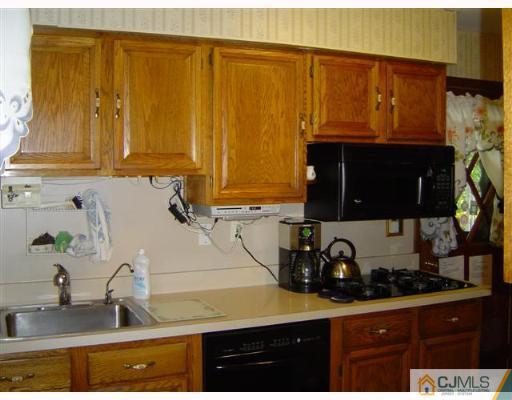 19 Georgetown Road Old Bridge, NJ 08859 - Photo 2 of 8 a kitchen with a sink and cabinets