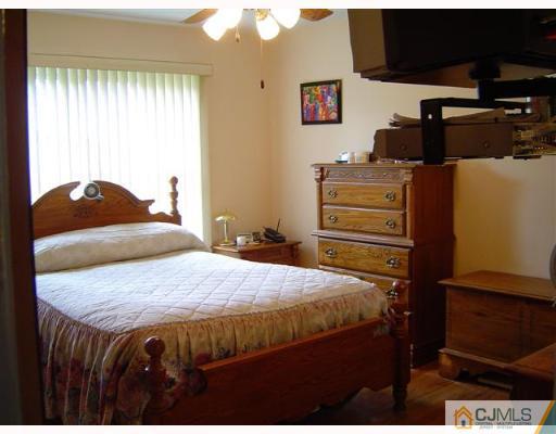 19 Georgetown Road Old Bridge, NJ 08859 - Photo 5 of 8 a bedroom with a bed and wooden floor
