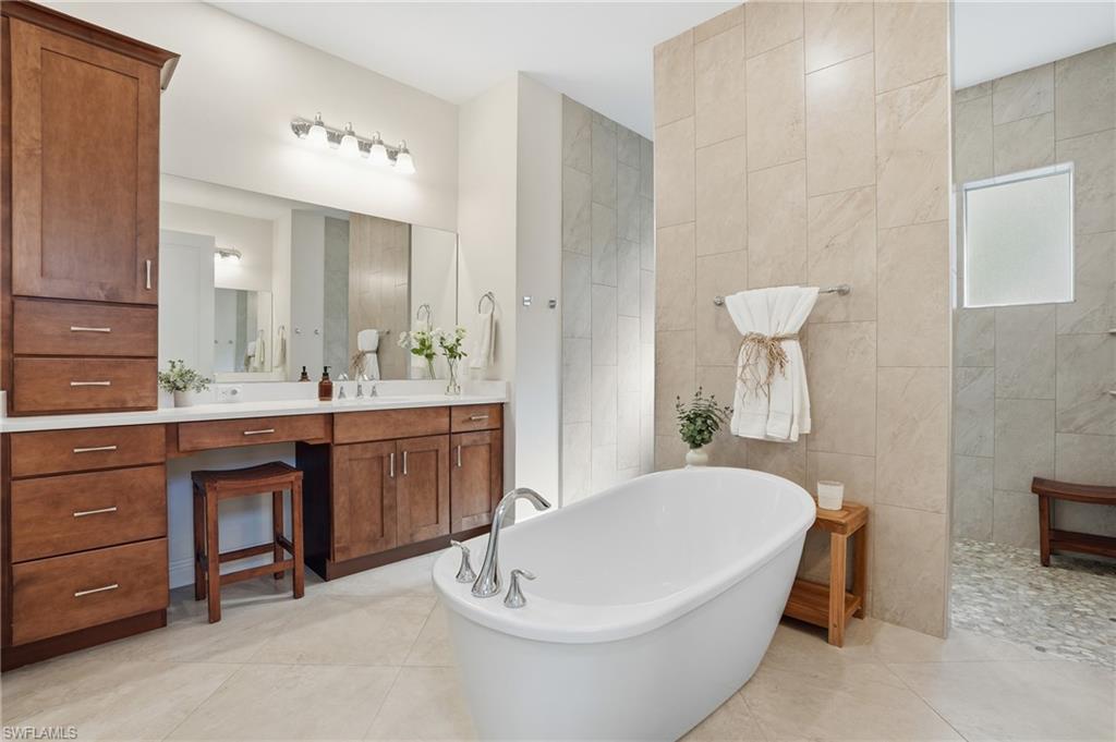 3707 5th Avenue Southwest Naples, FL 34117 - Photo 18 of 48 Full bath with vanity, walk around shower, a soaking tub, and natural light