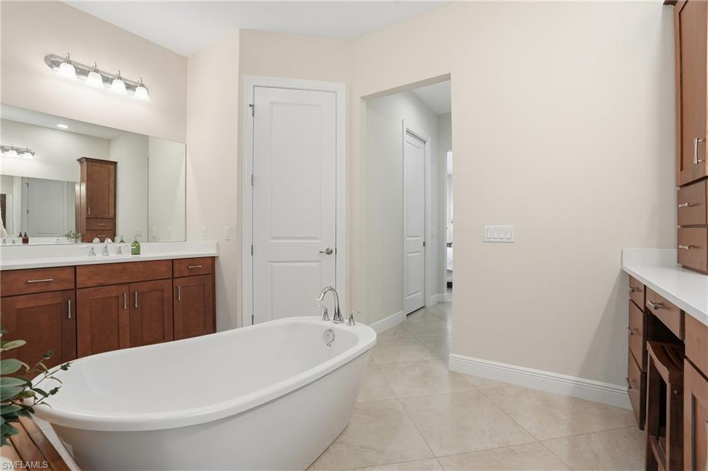 3707 5th Avenue Southwest Naples, FL 34117 - Photo 19 of 48 Full bathroom featuring vanity, a soaking tub, and private water closet