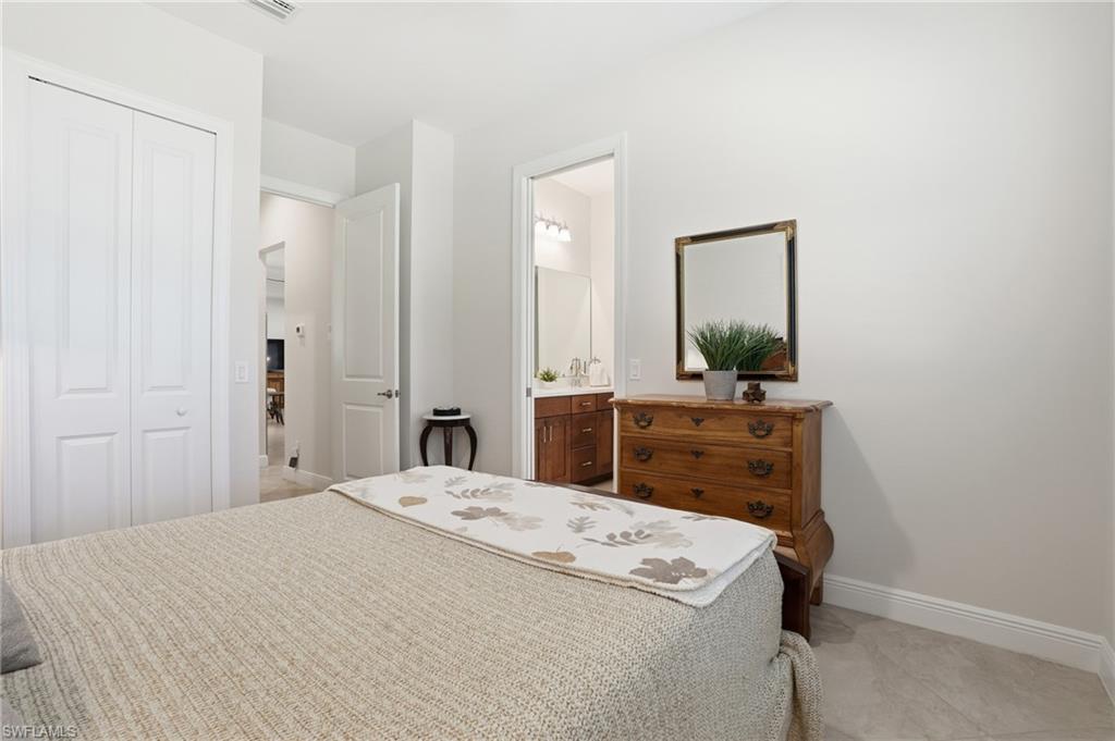 3707 5th Avenue Southwest Naples, FL 34117 - Photo 22 of 48 Bedroom with a closet and connected bathroom