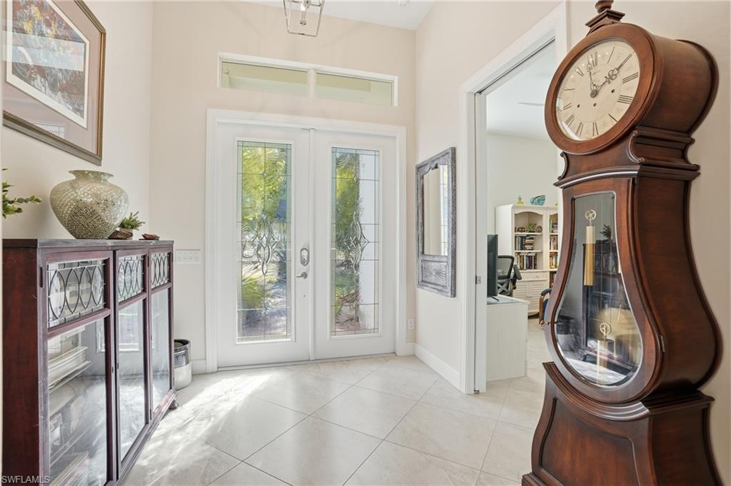 3707 5th Avenue Southwest Naples, FL 34117 - Photo 31 of 48 Foyer entrance with French doors allowing plenty of natural light through the lead glass doors and upper transom glass