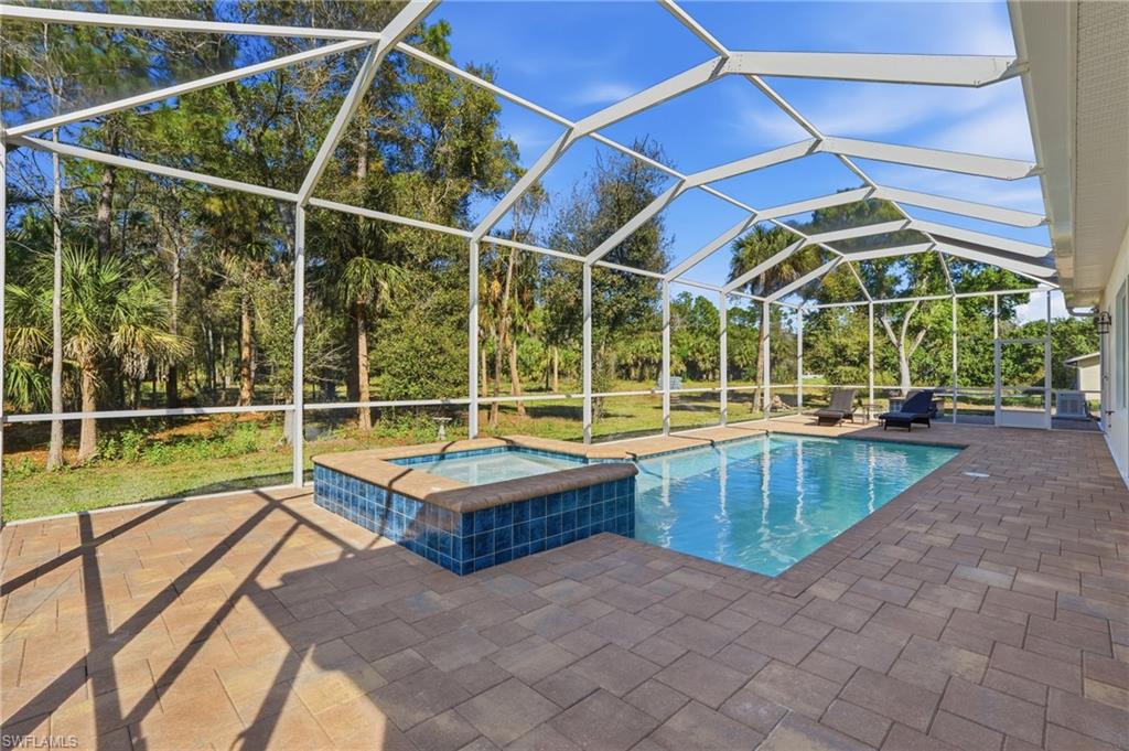 3707 5th Avenue Southwest Naples, FL 34117 - Photo 38 of 48 Pool and spa with extended screened pool cage and lanai