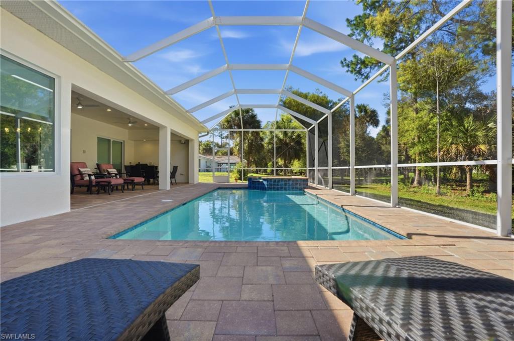 3707 5th Avenue Southwest Naples, FL 34117 - Photo 40 of 48 Pool and spa with extended screened pool cage and lanai