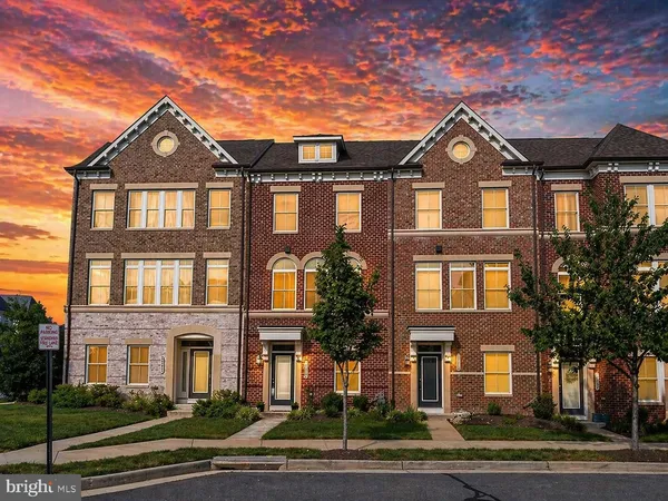 a front view of a residential apartment building with a yard