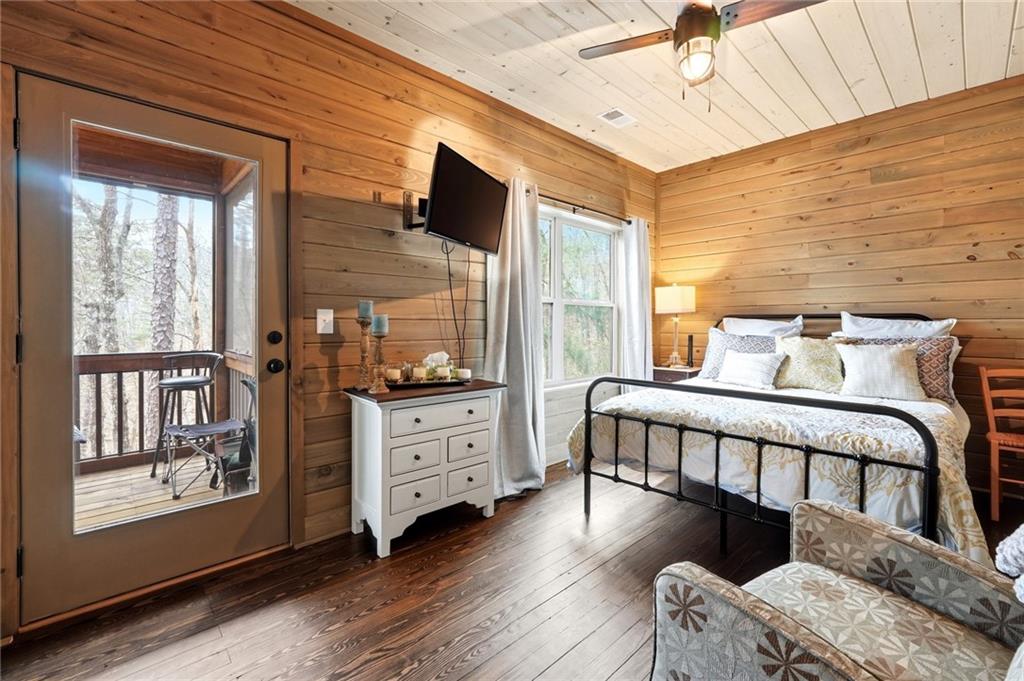 1041 Astro Court Northeast Ranger, GA 30734 - Photo 35 of 52 a bedroom with a bed and wooden floor