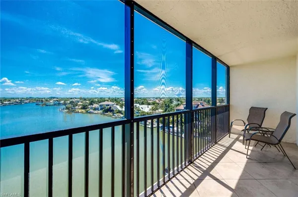 a view of a balcony with chair and wooden floor