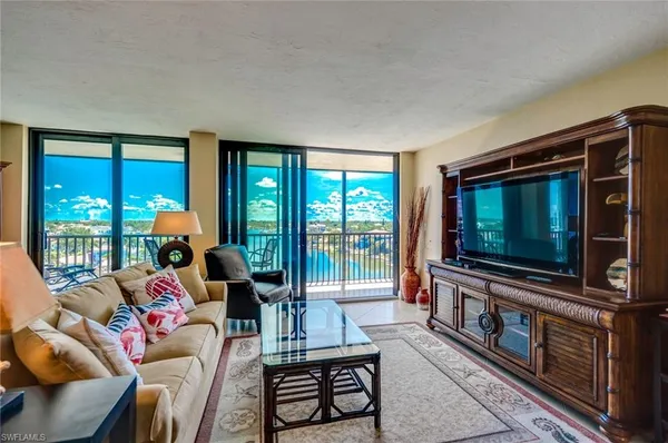 a living room with furniture and a floor to ceiling window
