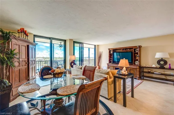 a dining room with furniture and wooden floor